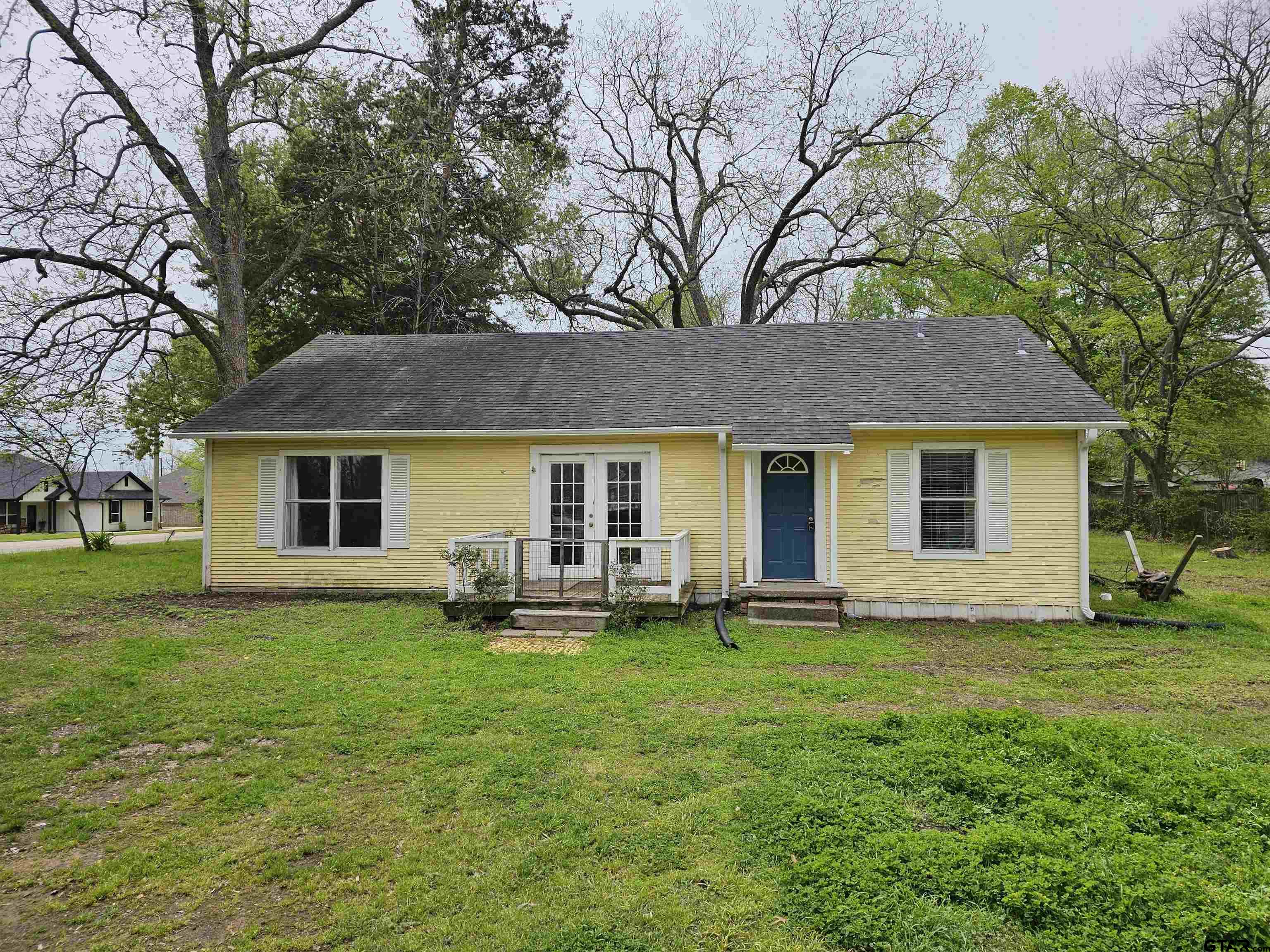 a view of a house with a yard and sitting area