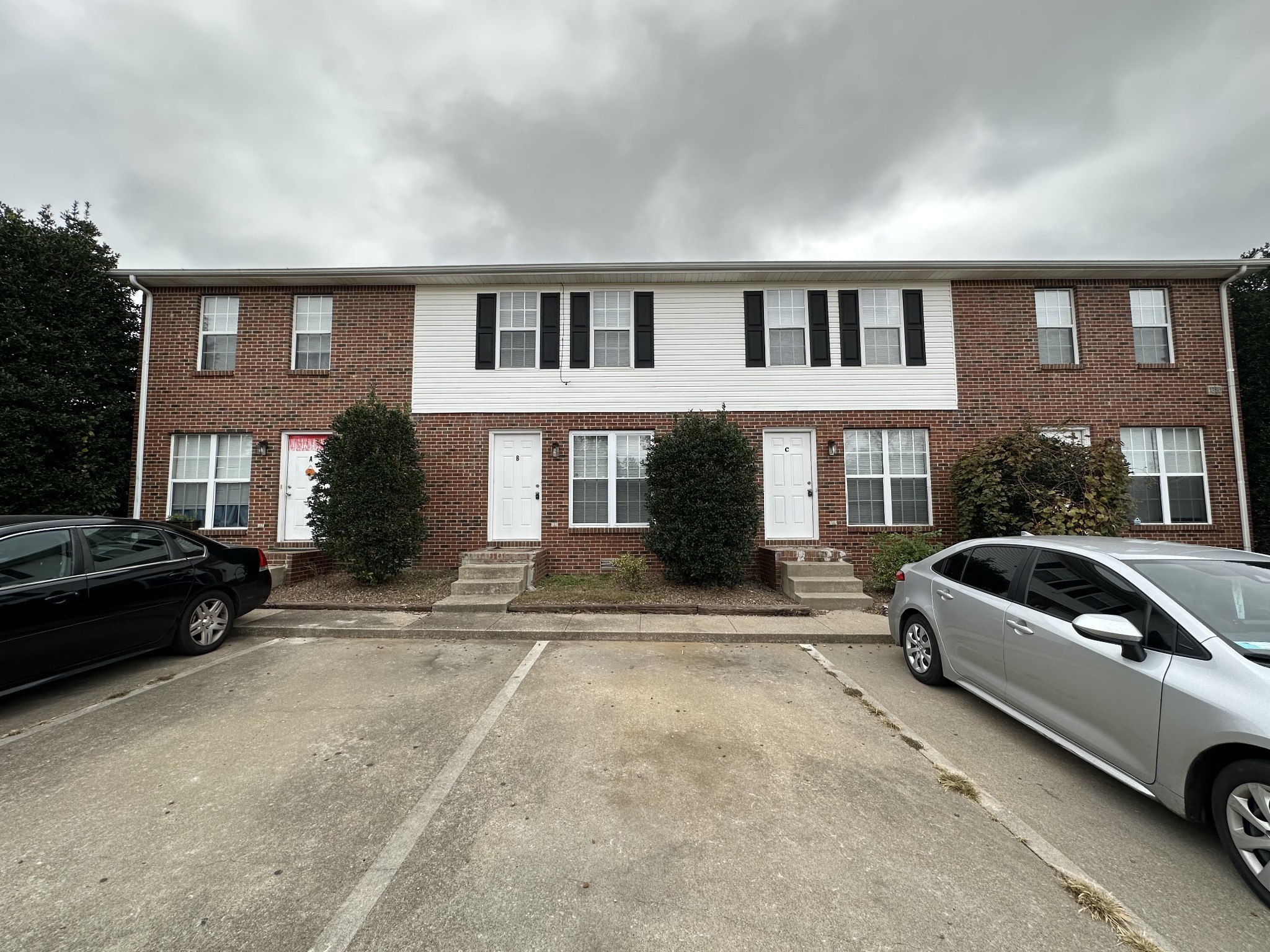 a view of a car parked in front of a brick house