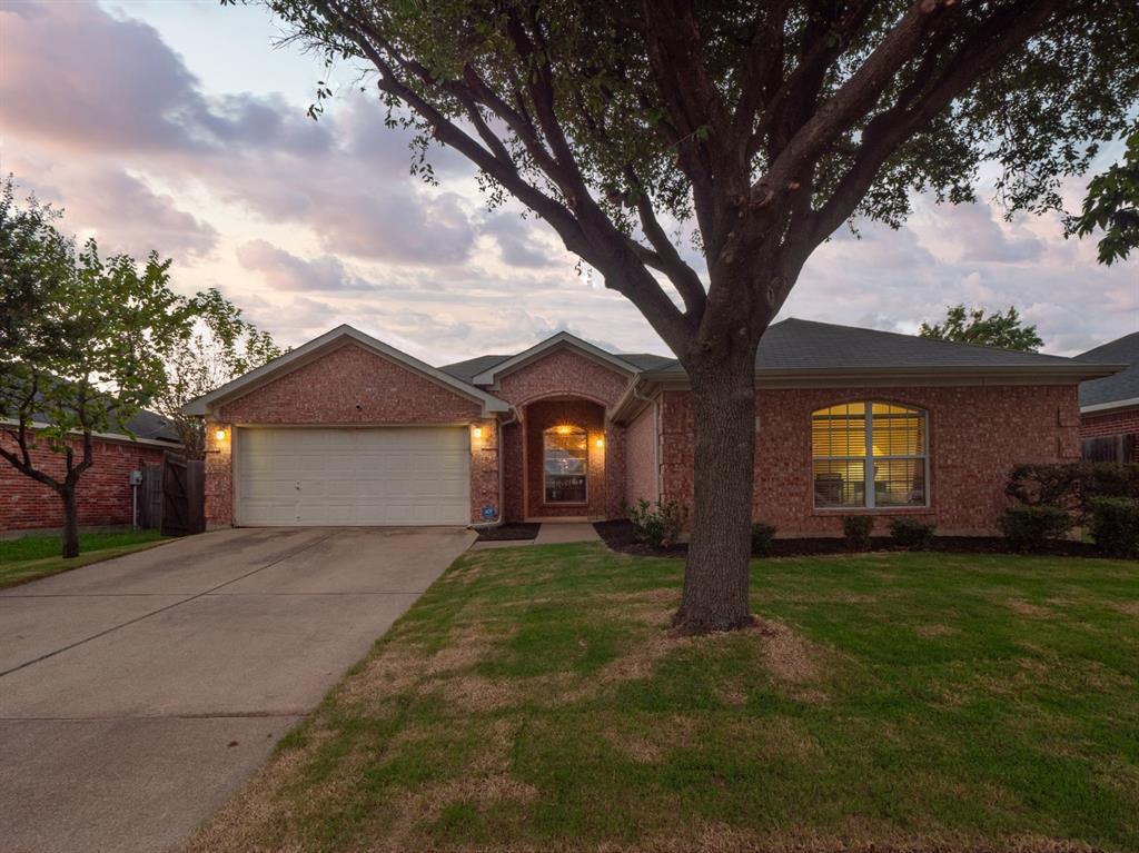 a big house with tree in front of it