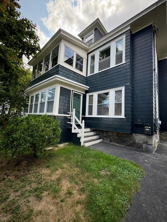 a front view of a house with garden