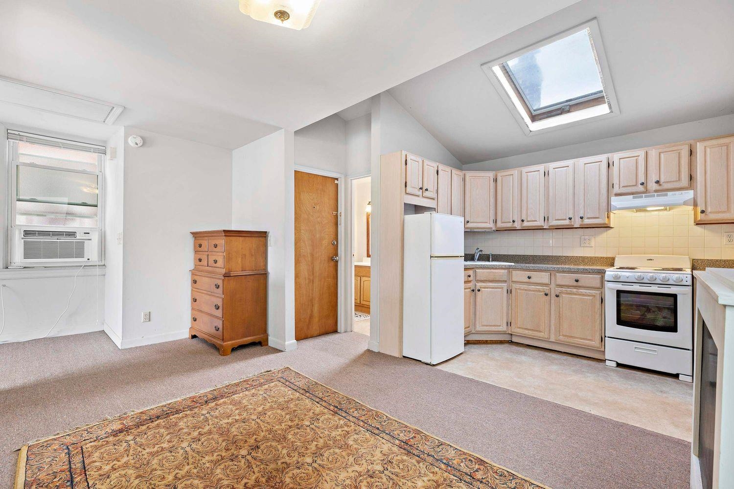 a kitchen with stainless steel appliances white cabinets and a refrigerator