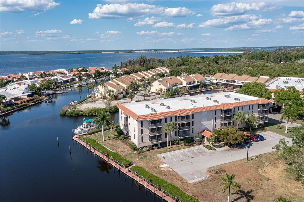 an aerial view of a house with a garden and lake view