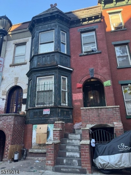 a front view of a house with parking space