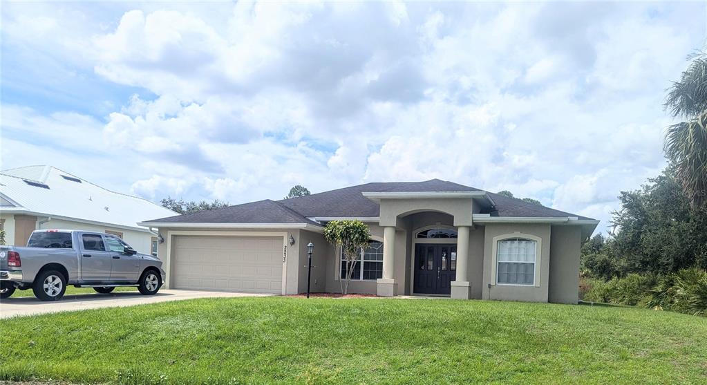 a front view of a house with a garden and yard