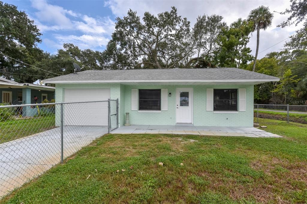 a front view of house with yard and green space