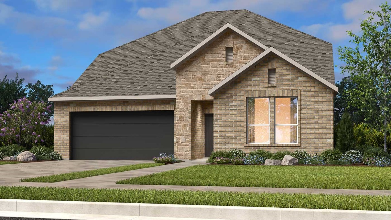 a front view of a house with a garden and yard