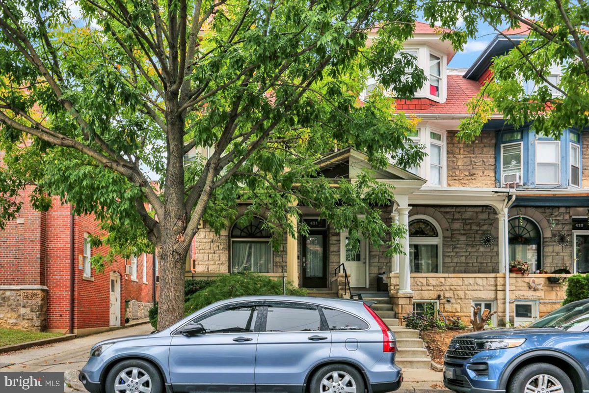 a front view of a house with parking area