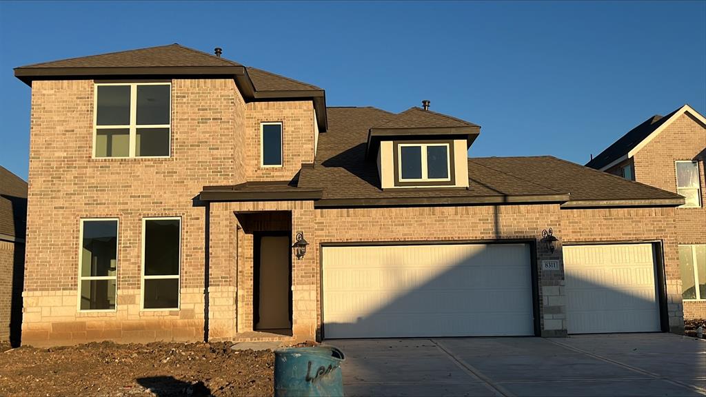 a front view of a house with garage