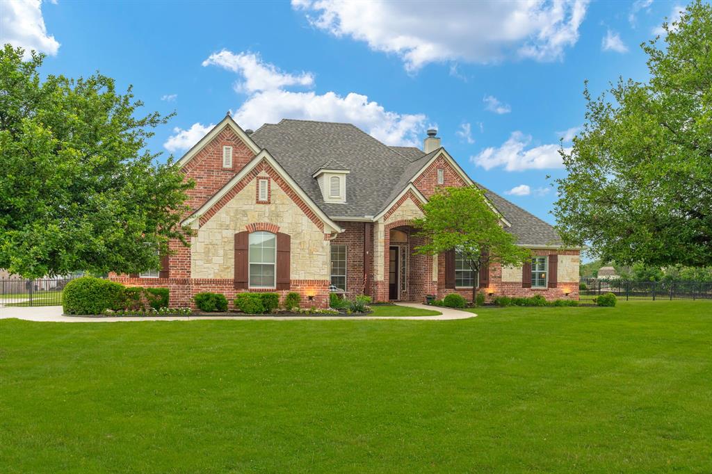 a front view of house with yard and green space