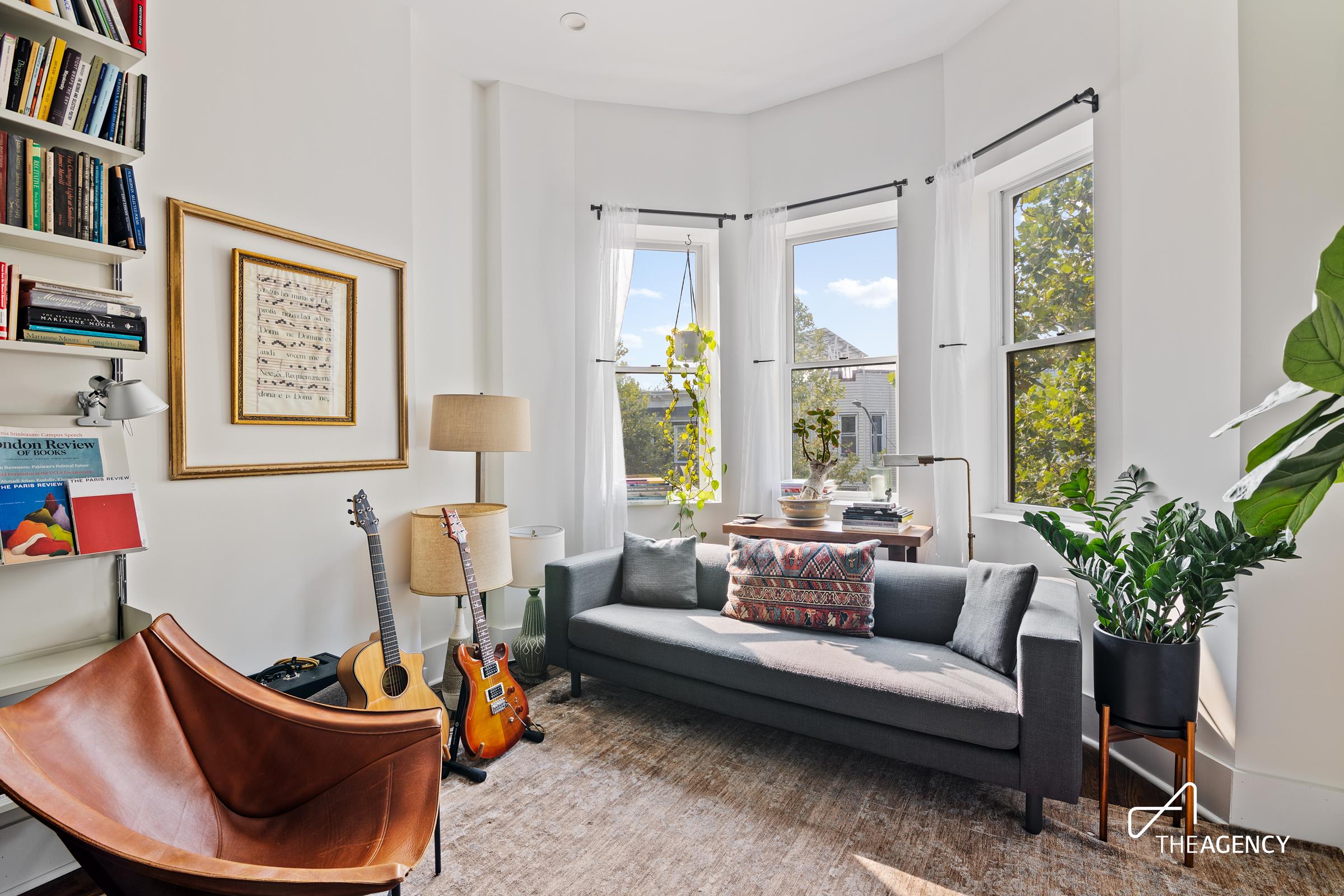 a living room with furniture and a potted plant