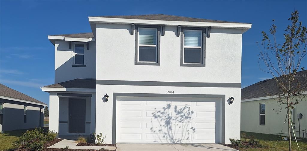 a front view of a house with garage