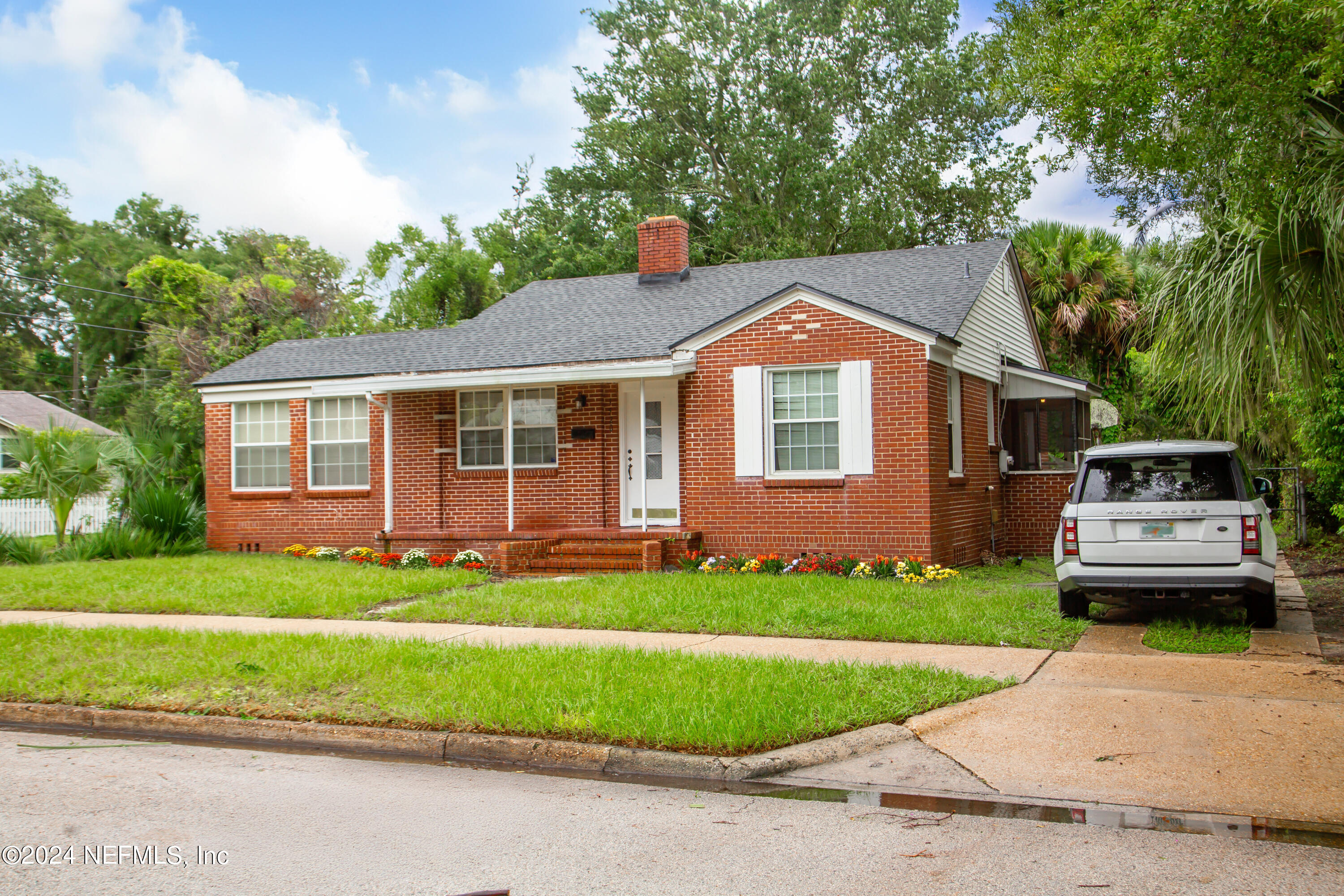 a front view of a house with a garden