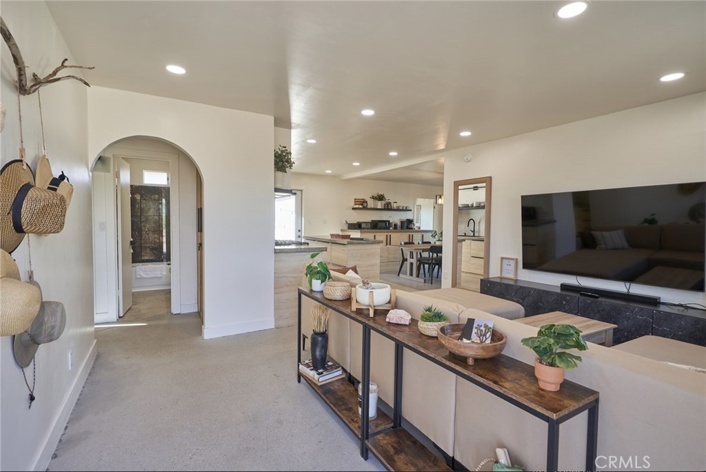 a kitchen with stainless steel appliances kitchen island granite countertop a lot of cabinets and wooden floor