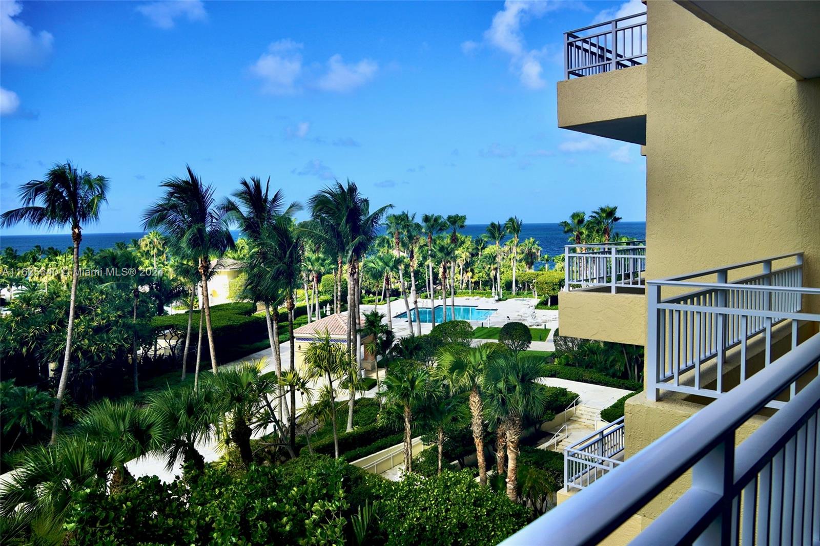 a view of balcony with two plants and a yard