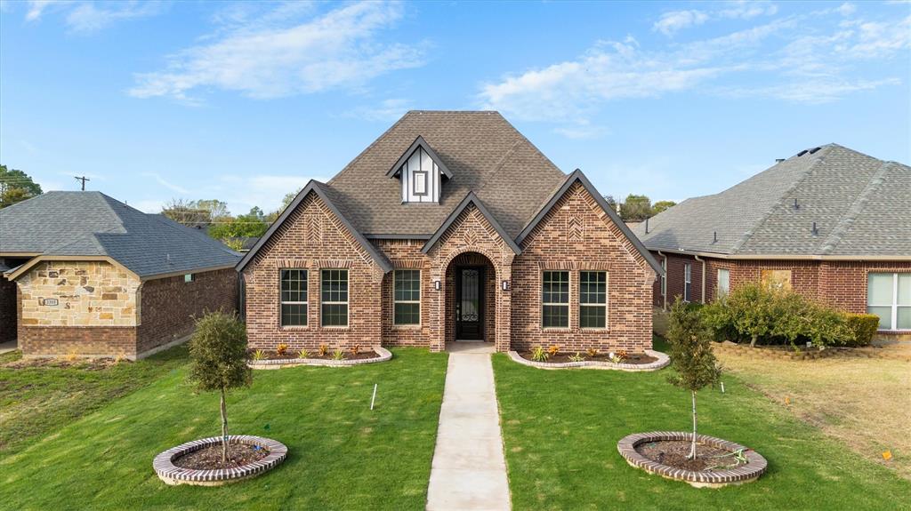 a front view of a house with a yard