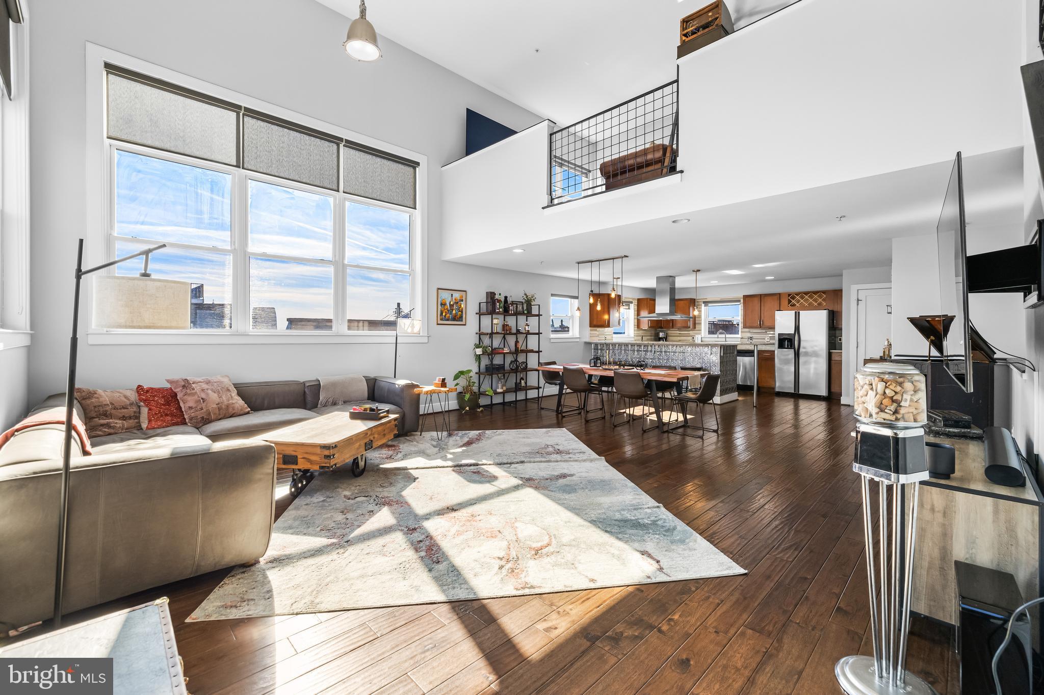 a living room with lots of furniture and a large window