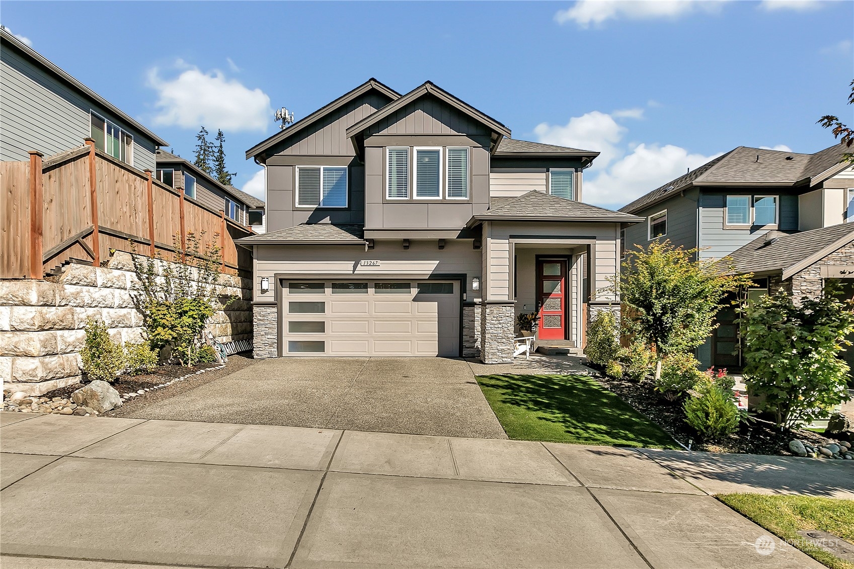 a front view of a house with a yard and garage