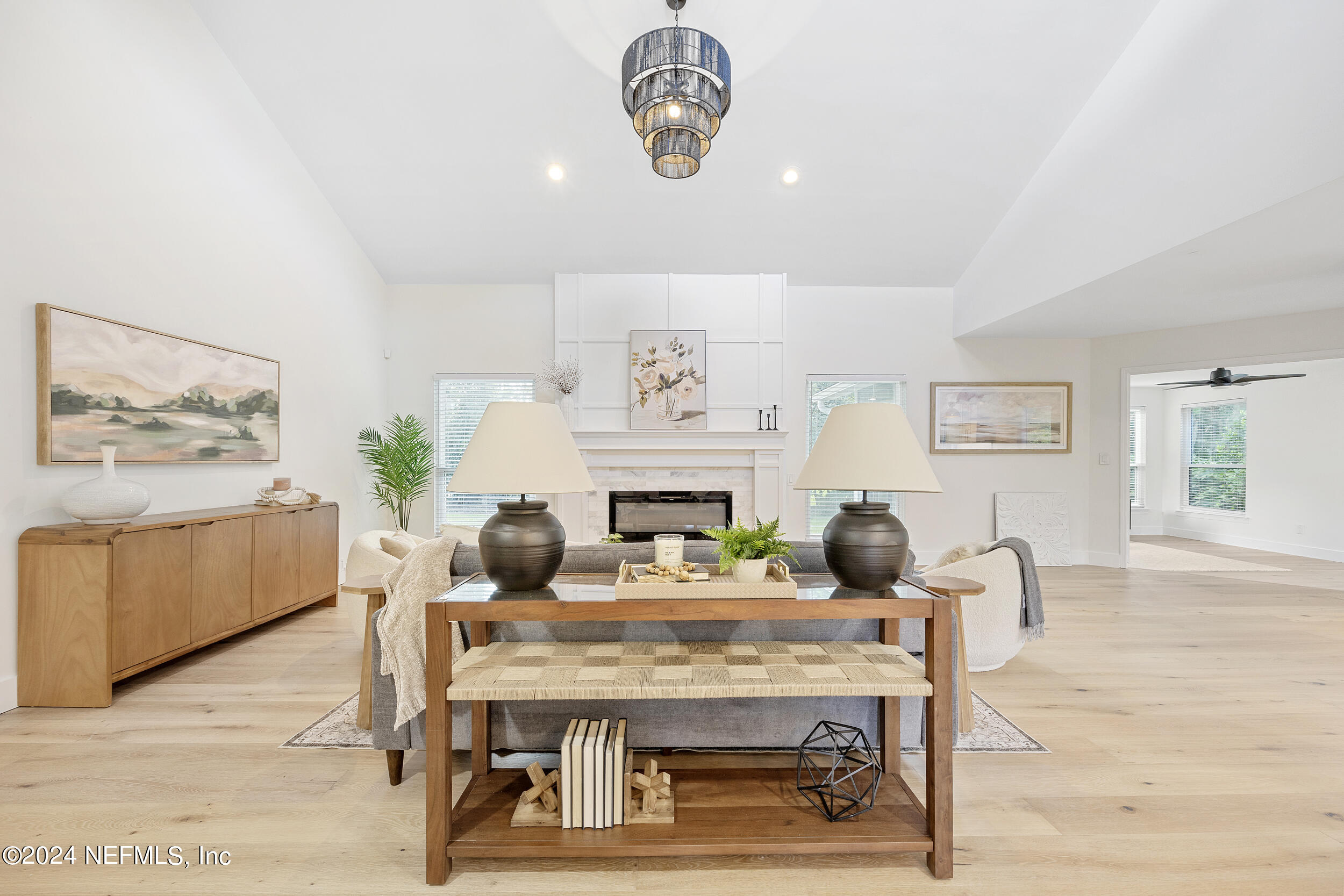 a dining room with furniture a rug a fireplace and wooden floor