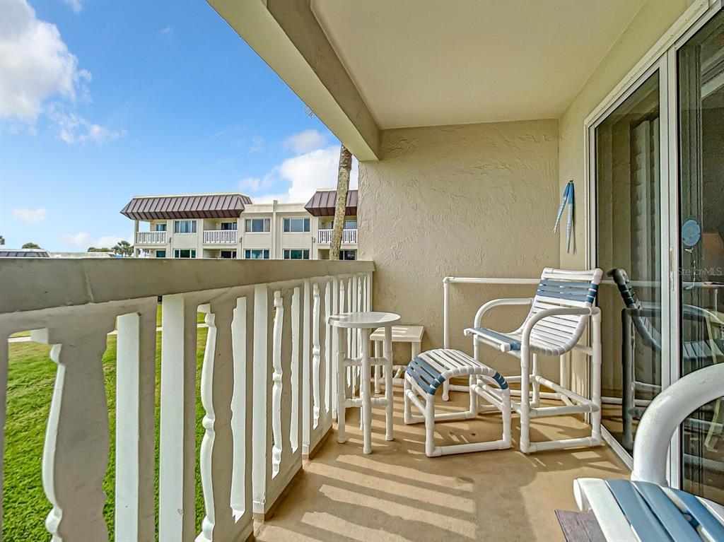 a view of a balcony with chairs