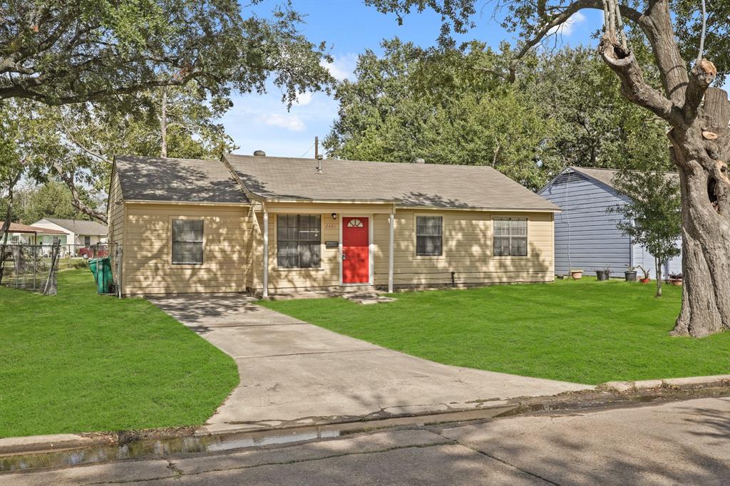 a front view of a house with a yard and trees