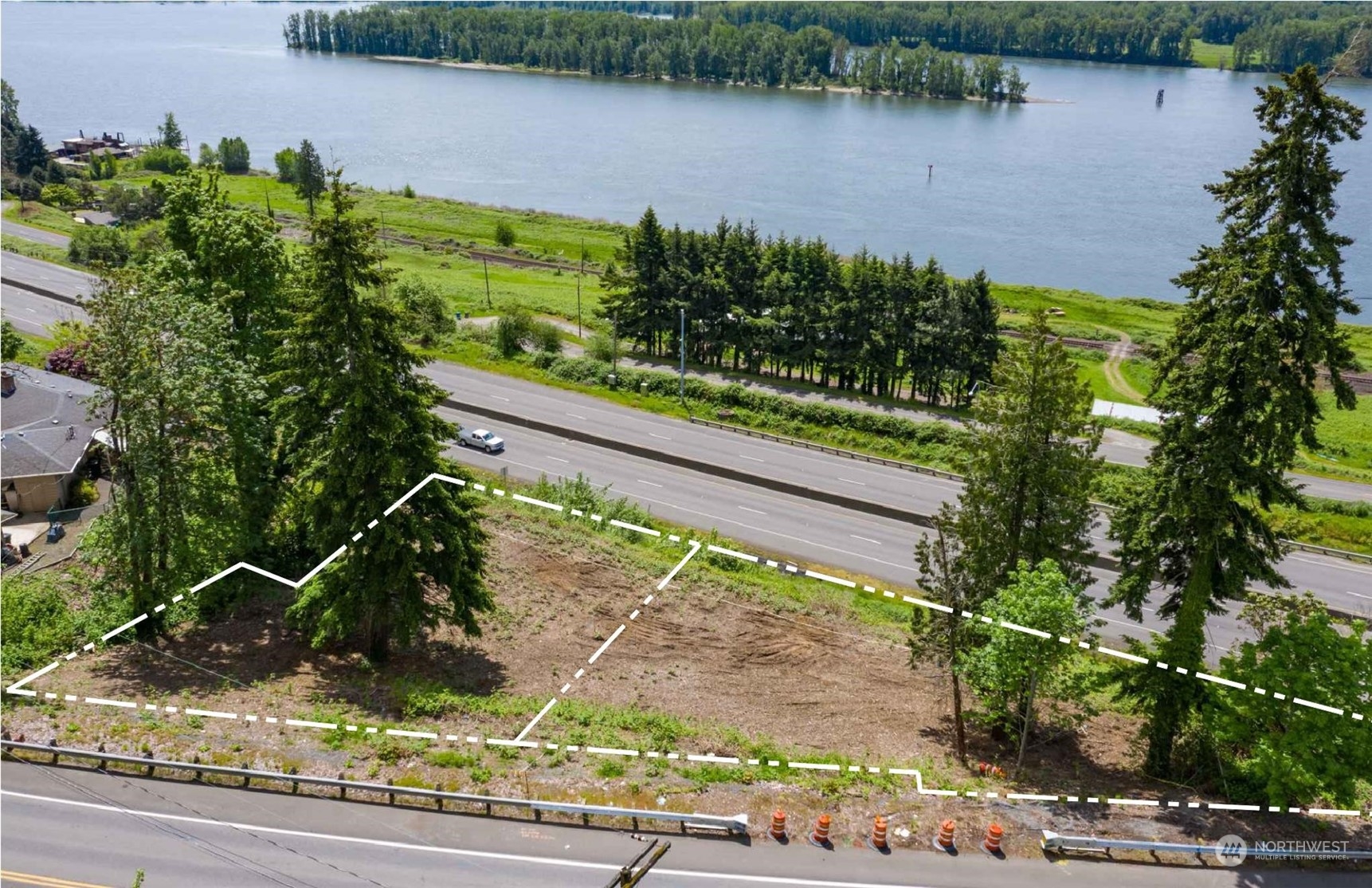 a view of a lake with a yard and potted plants