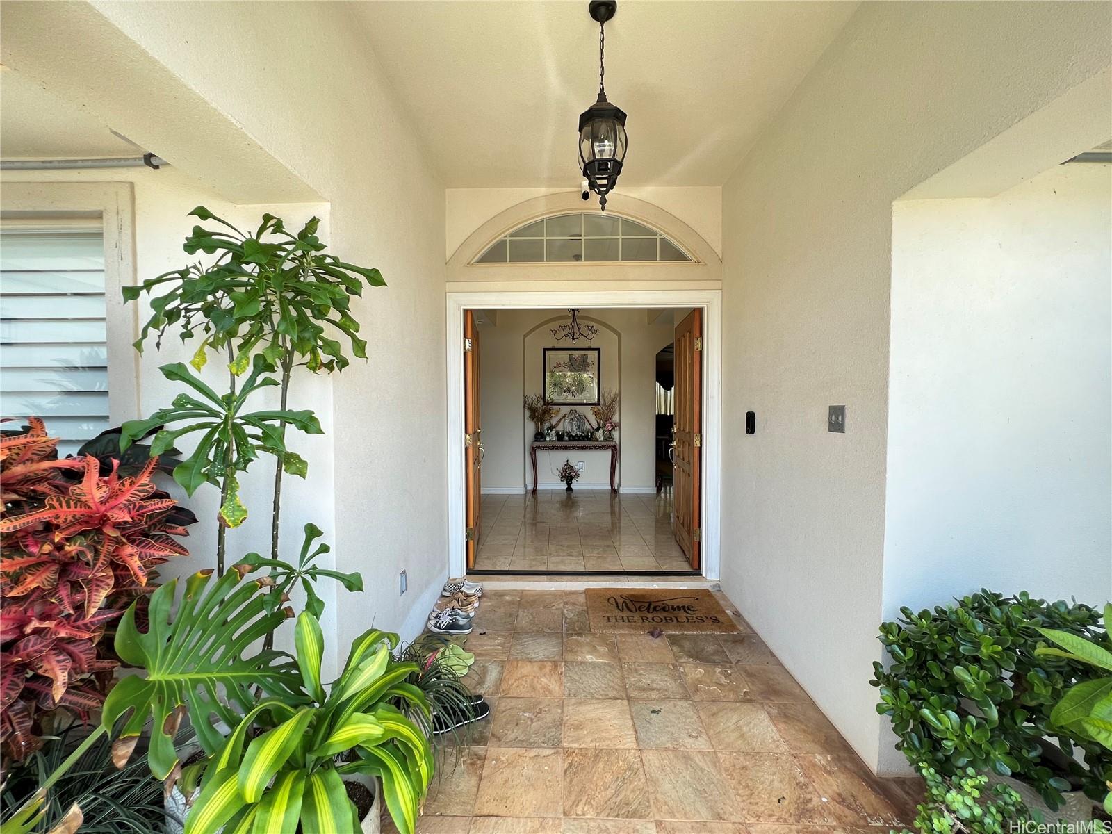 a view of a hallway with potted plants