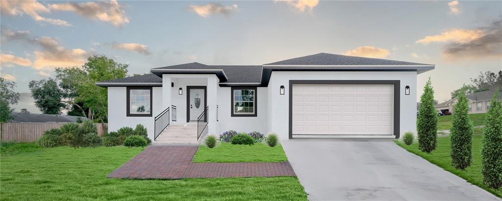 a front view of a house with a yard and garage