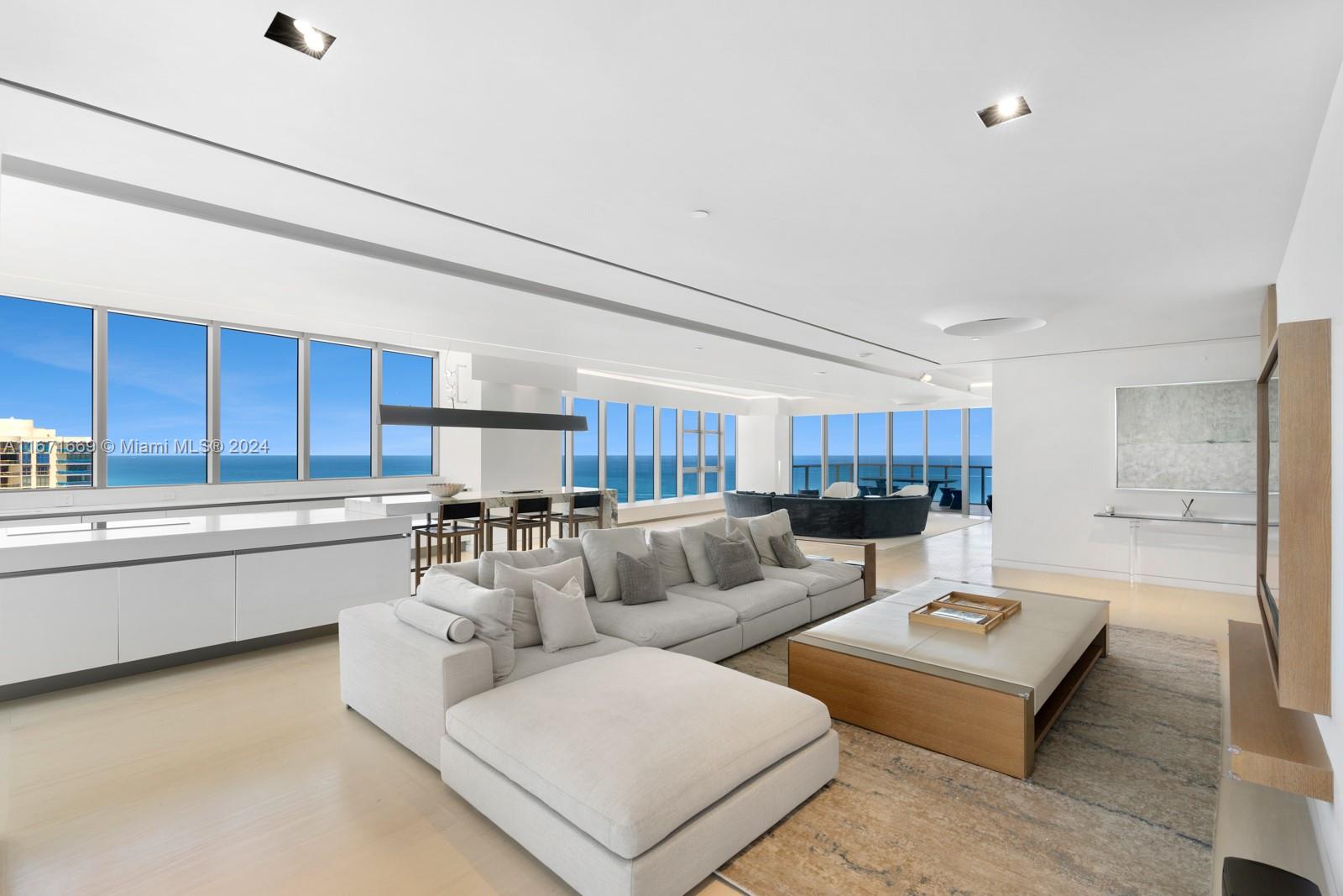 a living room with furniture and a kitchen view