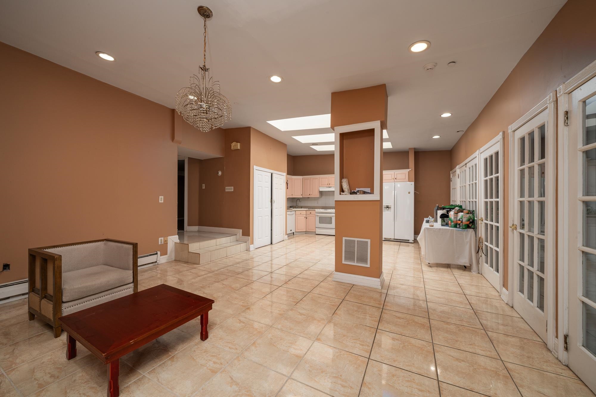 a room with stainless steel appliances kitchen island granite countertop furniture and a view of kitchen