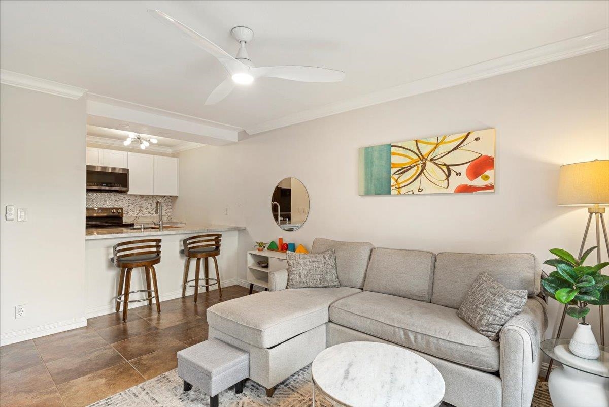 a living room with furniture and a kitchen view