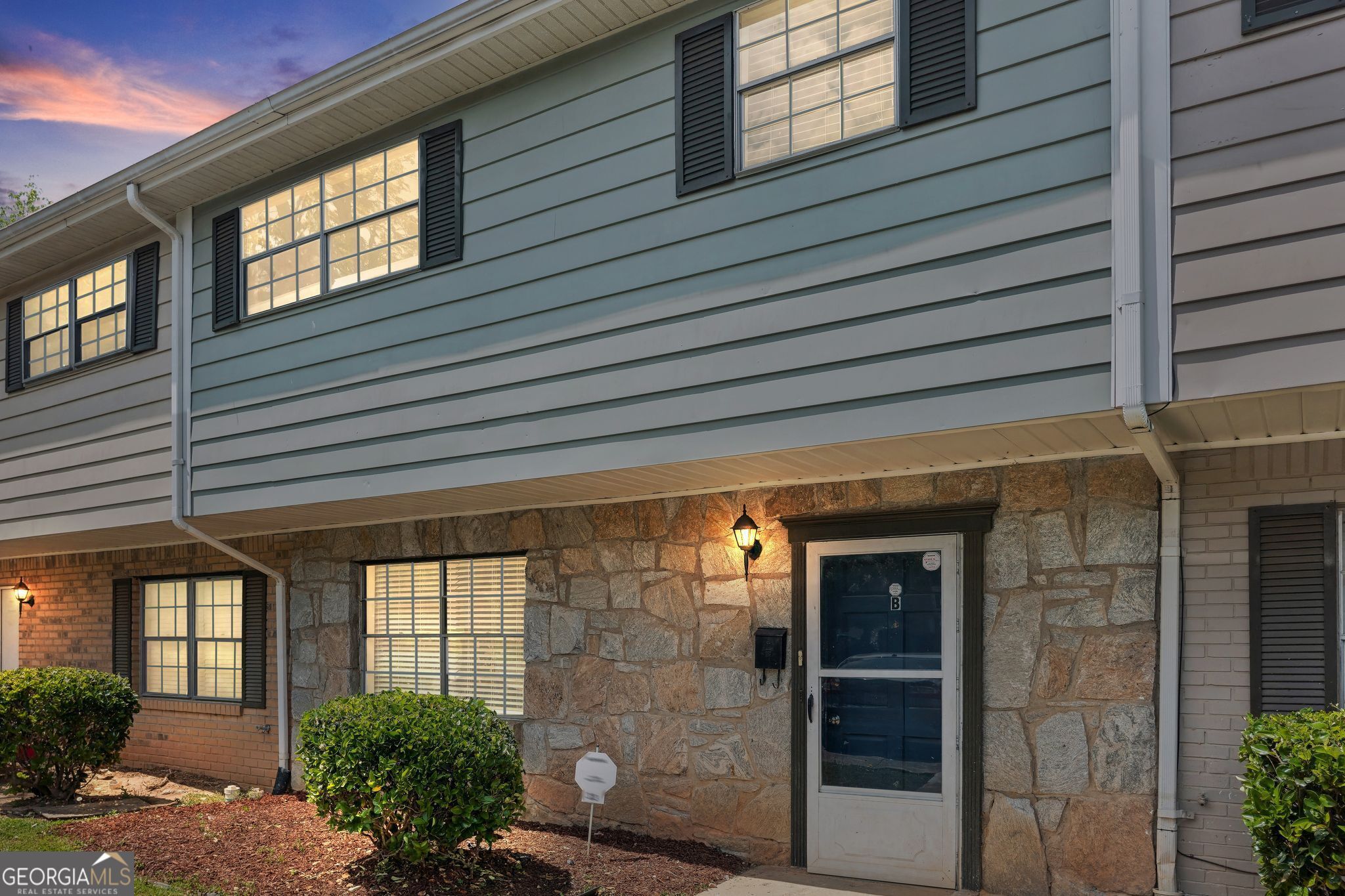 a front view of a house with a glass windows and garage