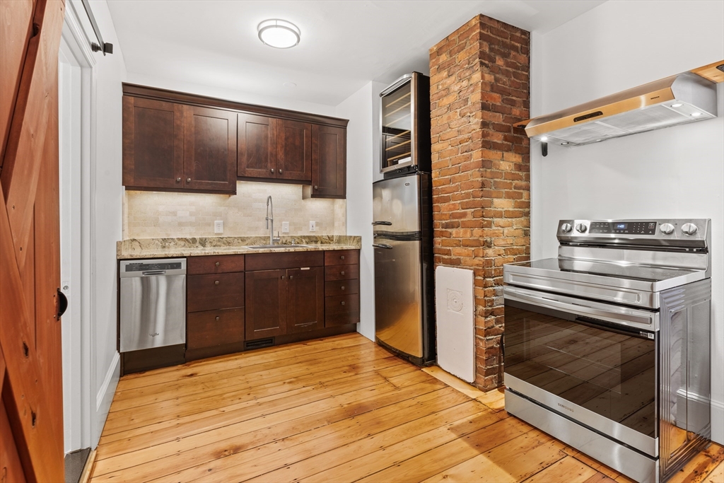 a kitchen with stainless steel appliances granite countertop a stove and a refrigerator