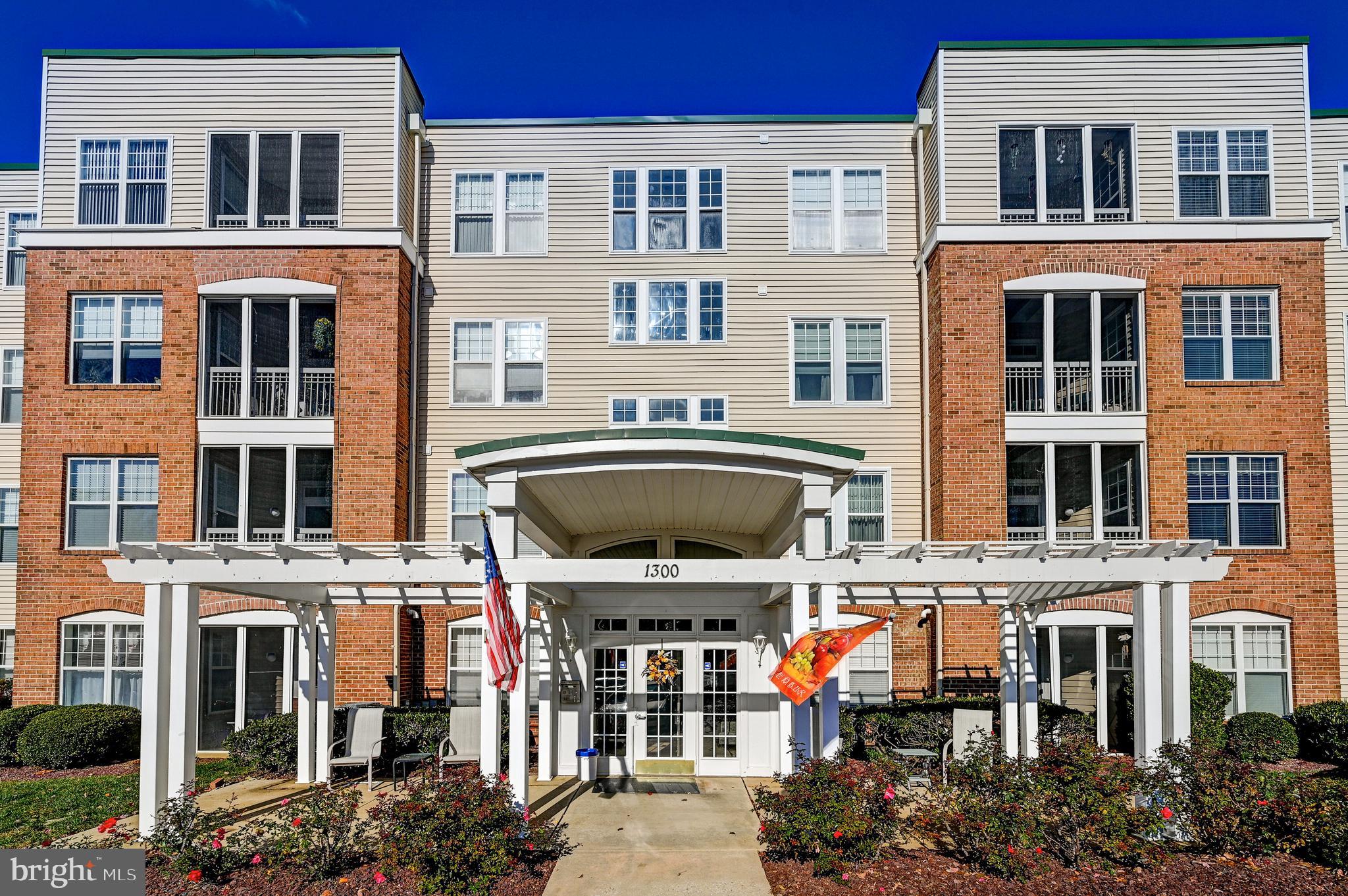 a front view of a residential apartment building with a yard