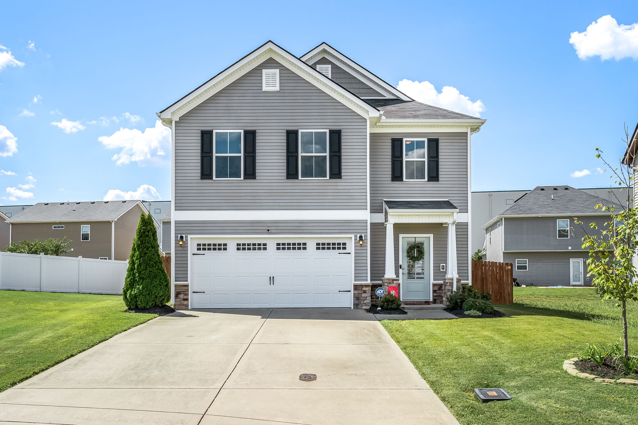 a front view of a house with a yard and a garage