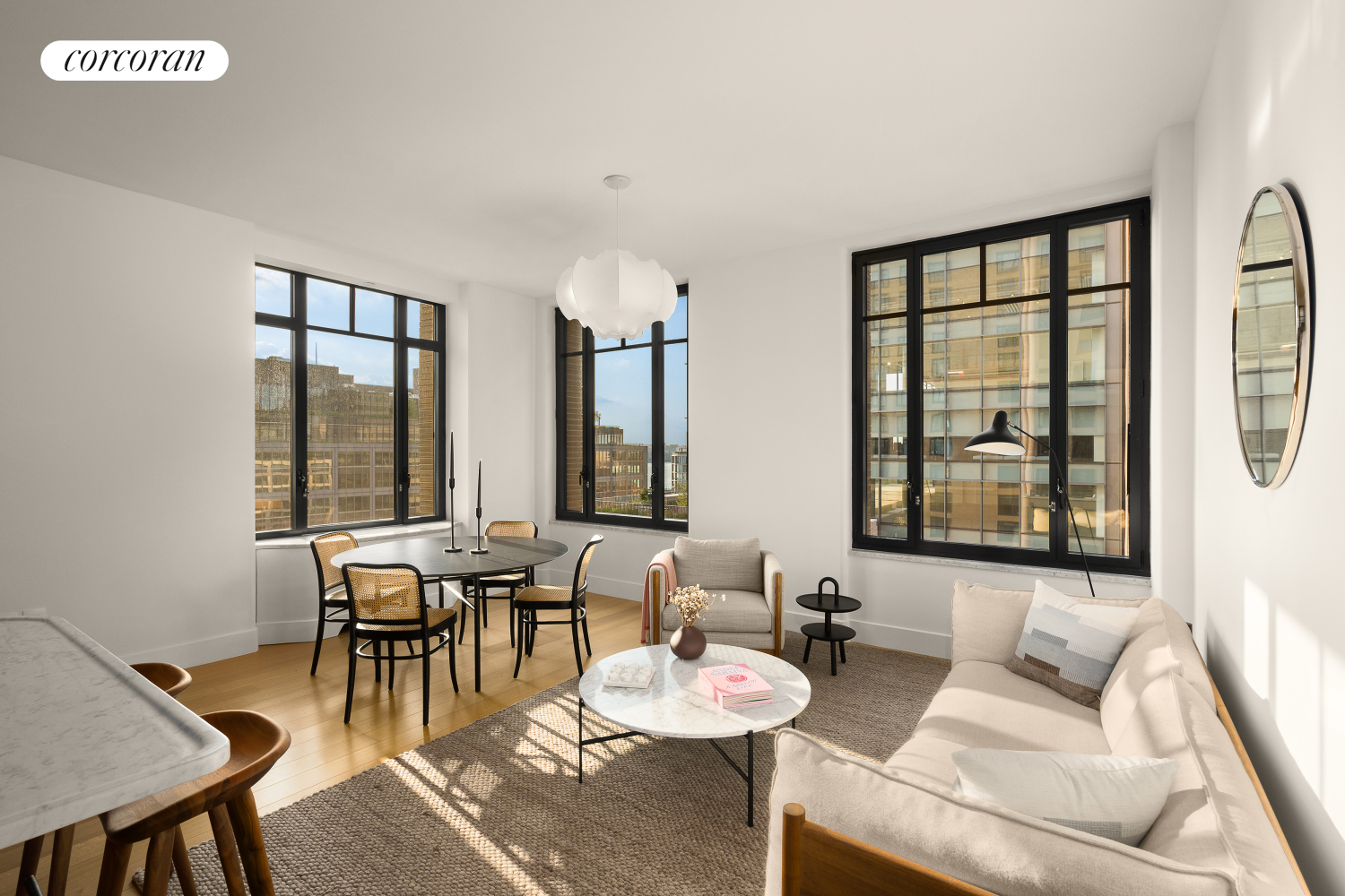 a living room with furniture and floor to ceiling windows