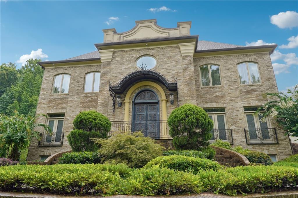 a front view of a house with a garden