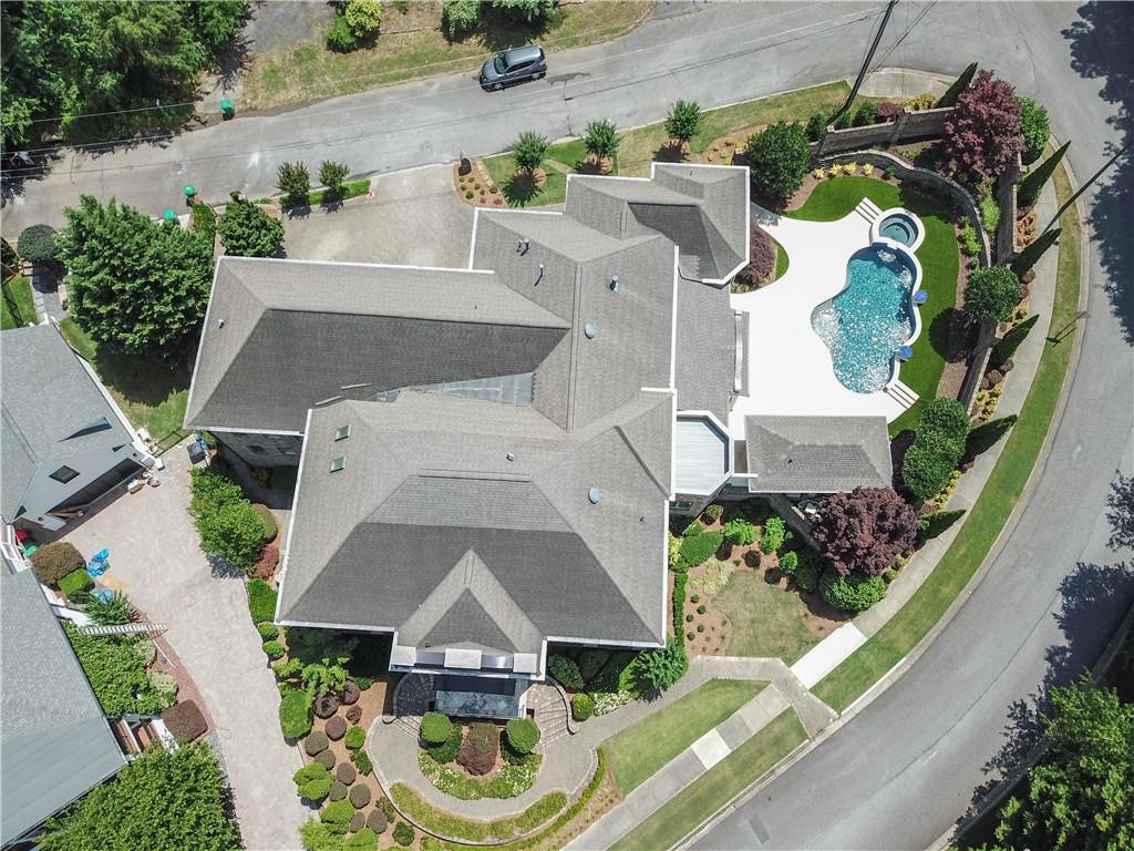 an aerial view of a house with a yard swimming pool