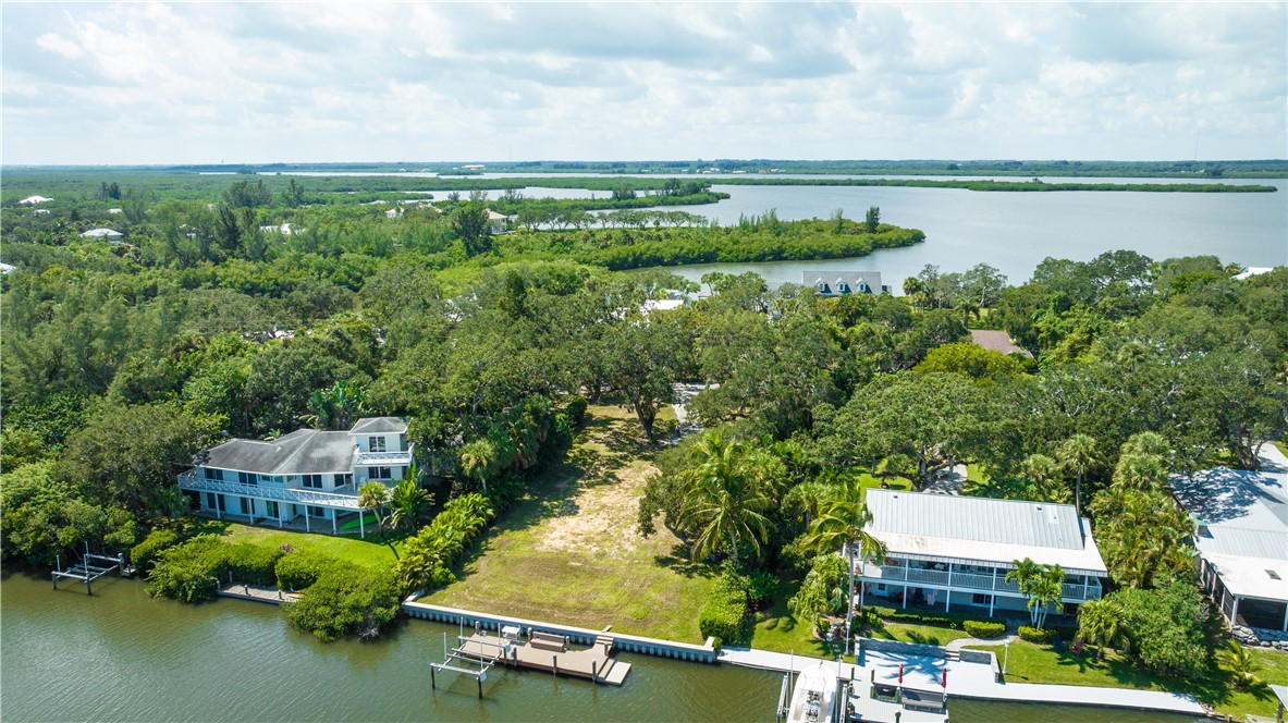 an aerial view of a house with a lake view