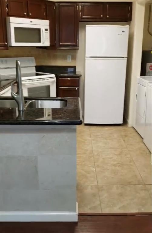 a kitchen with a refrigerator and a stove