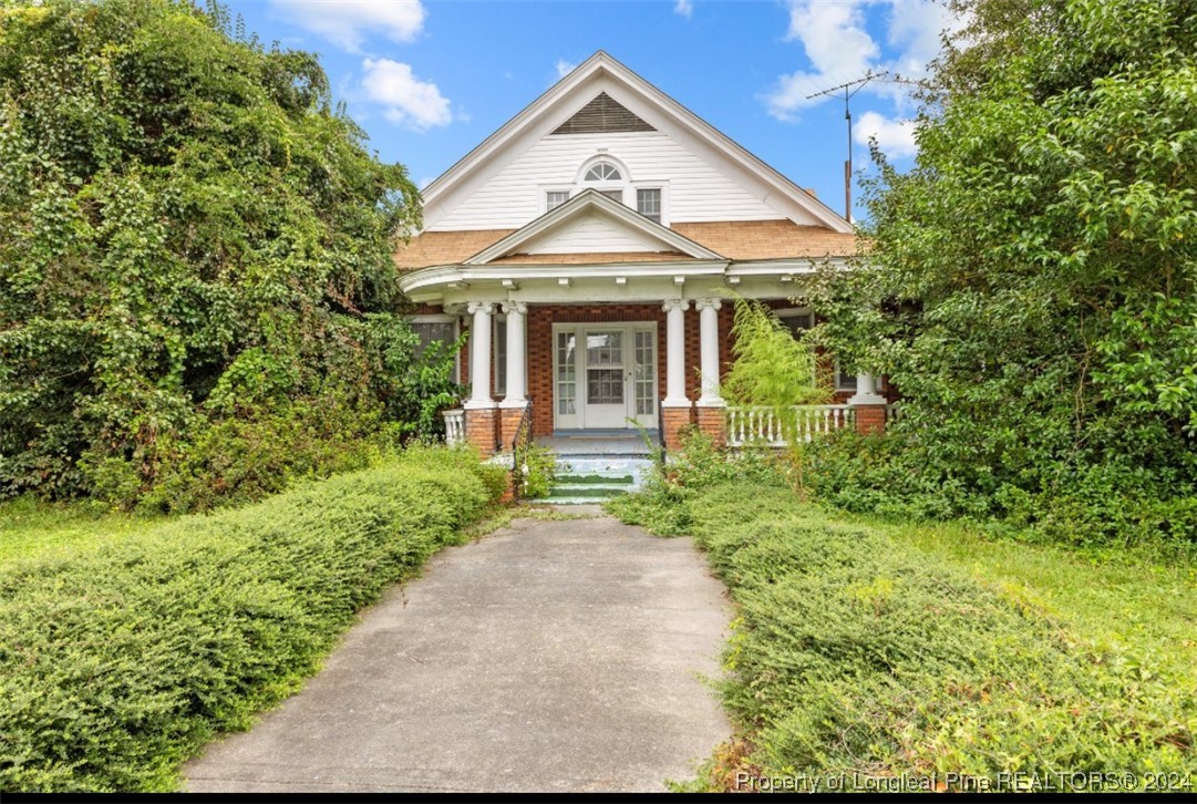 a front view of a house with garden