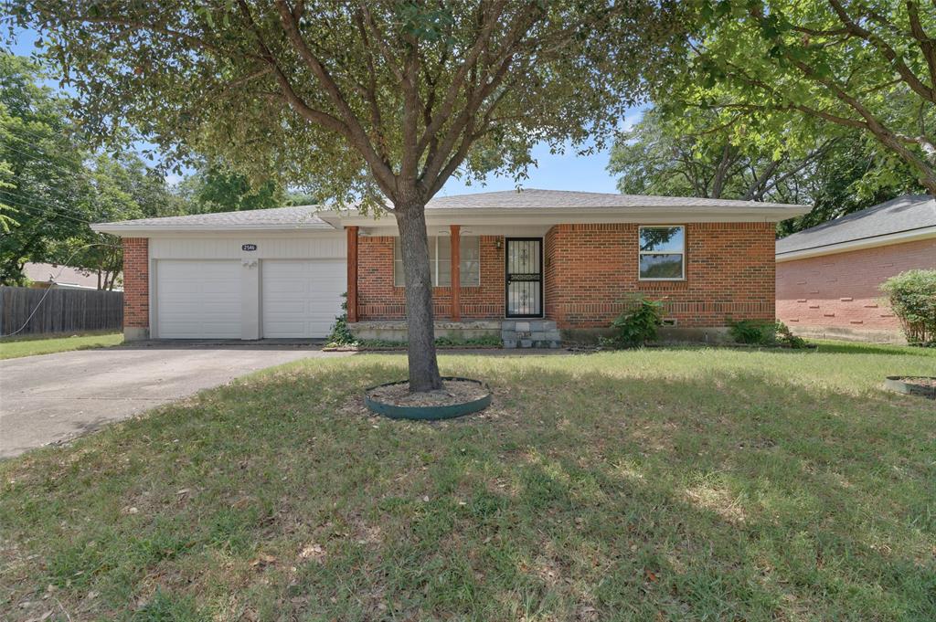 a front view of house with yard and trees