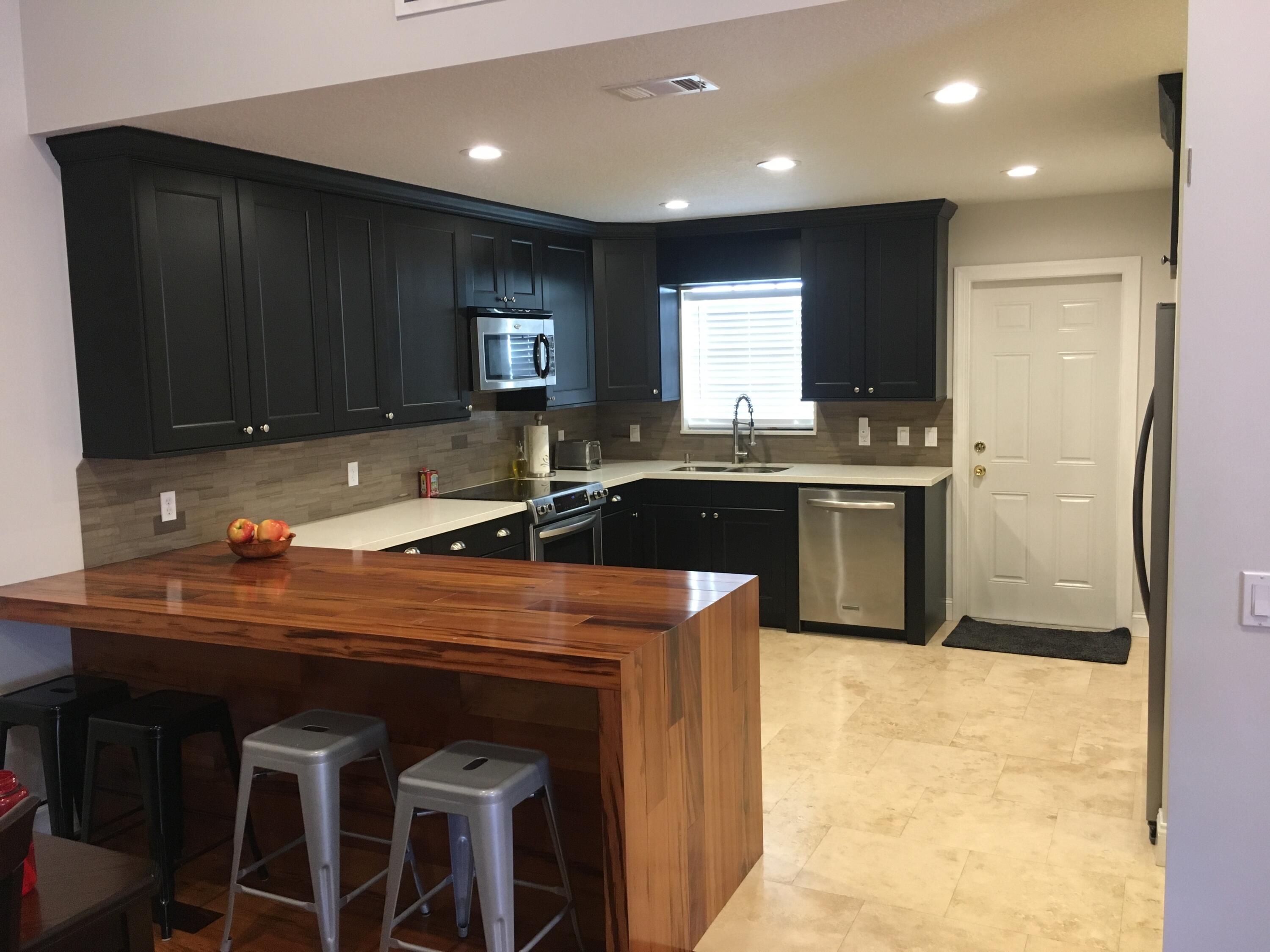 a kitchen with stainless steel appliances granite countertop a sink and a stove