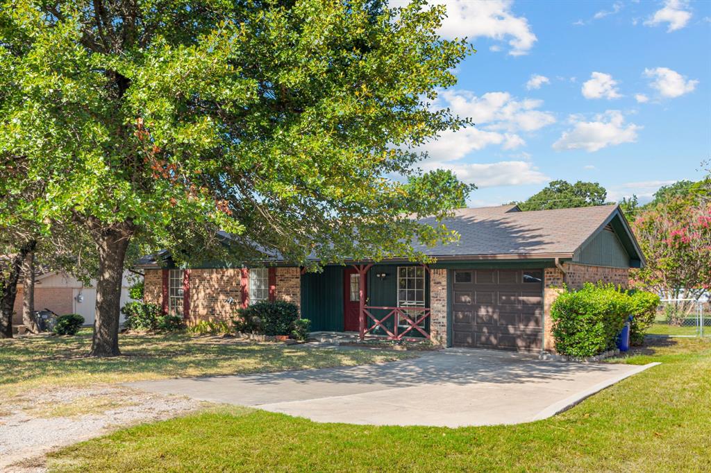 a view of a house with a yard and tree s