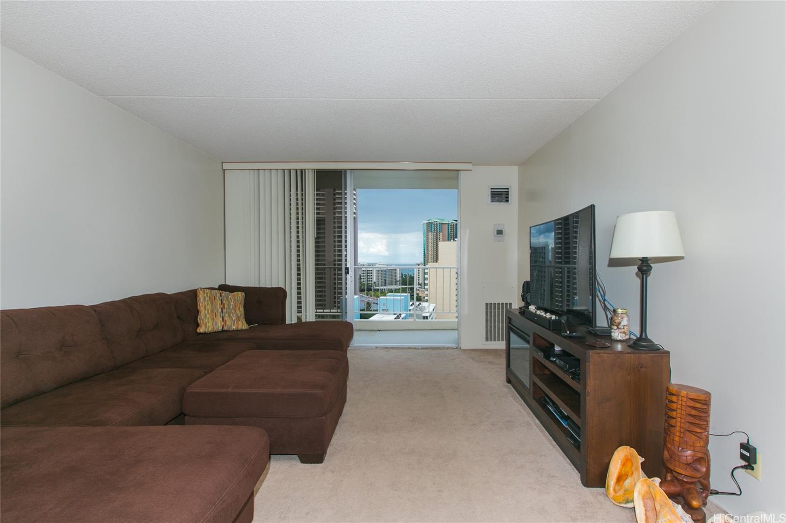 a living room with furniture a lamp and a flat screen tv