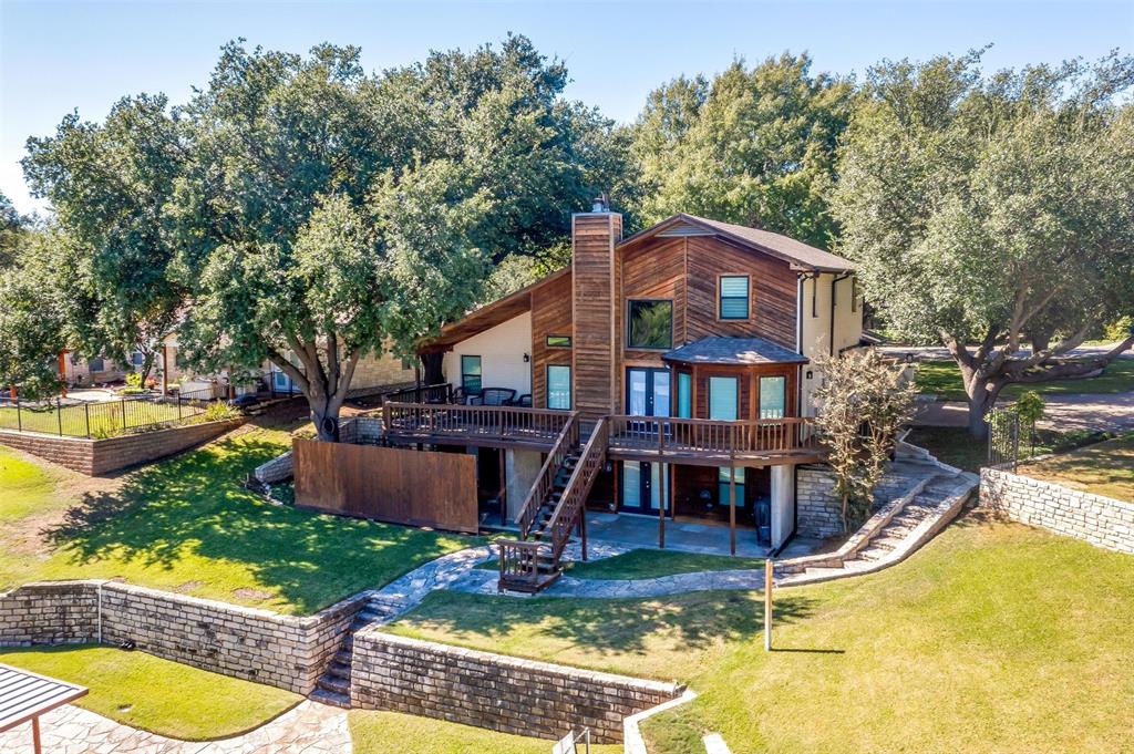 an aerial view of a house with swimming pool and a yard