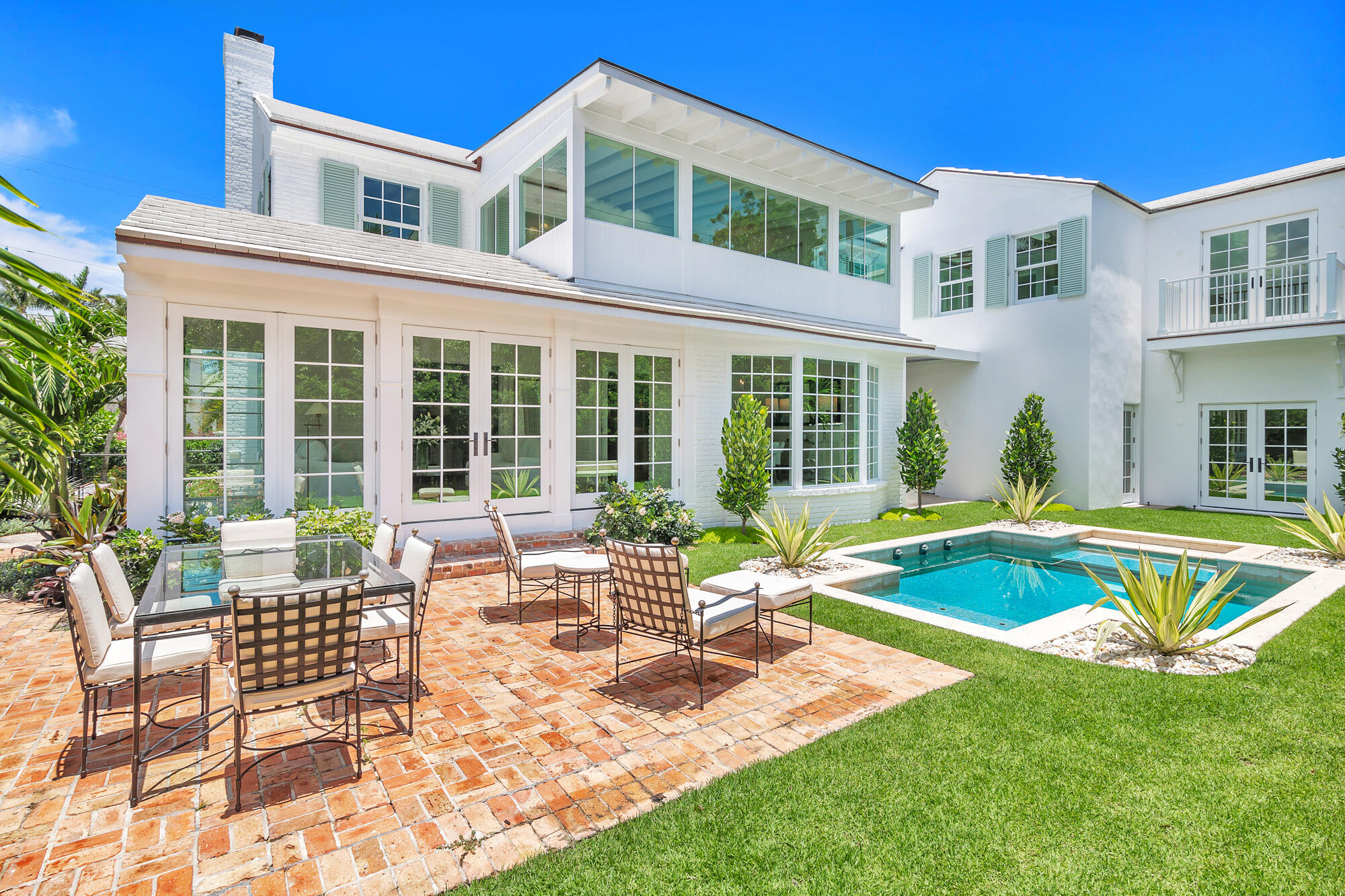 a view of a house with swimming pool and porch