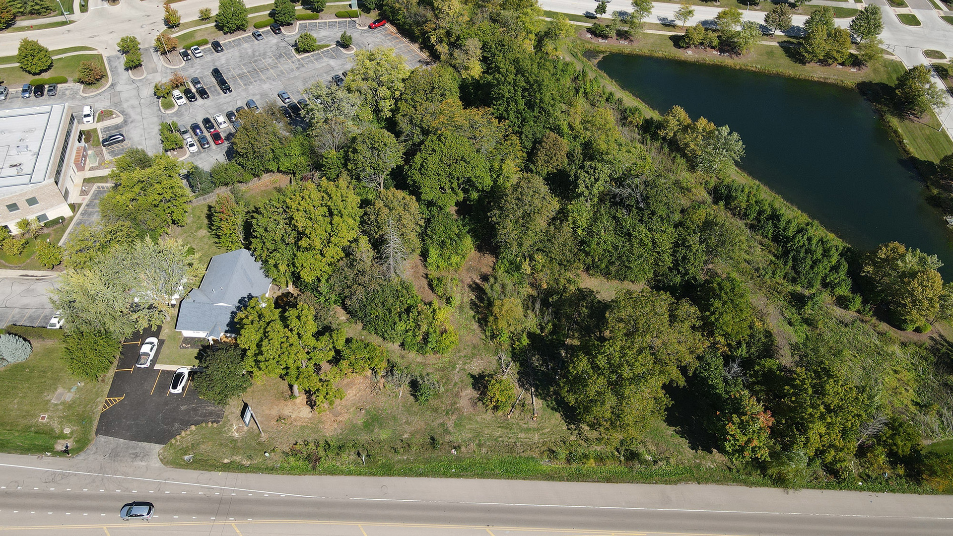 an aerial view of a house with a yard and lake view