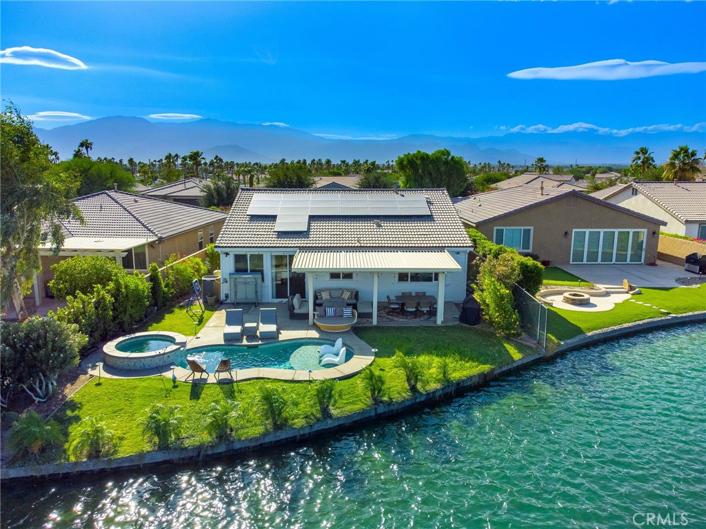 an aerial view of a house with a big yard swimming pool and outdoor seating