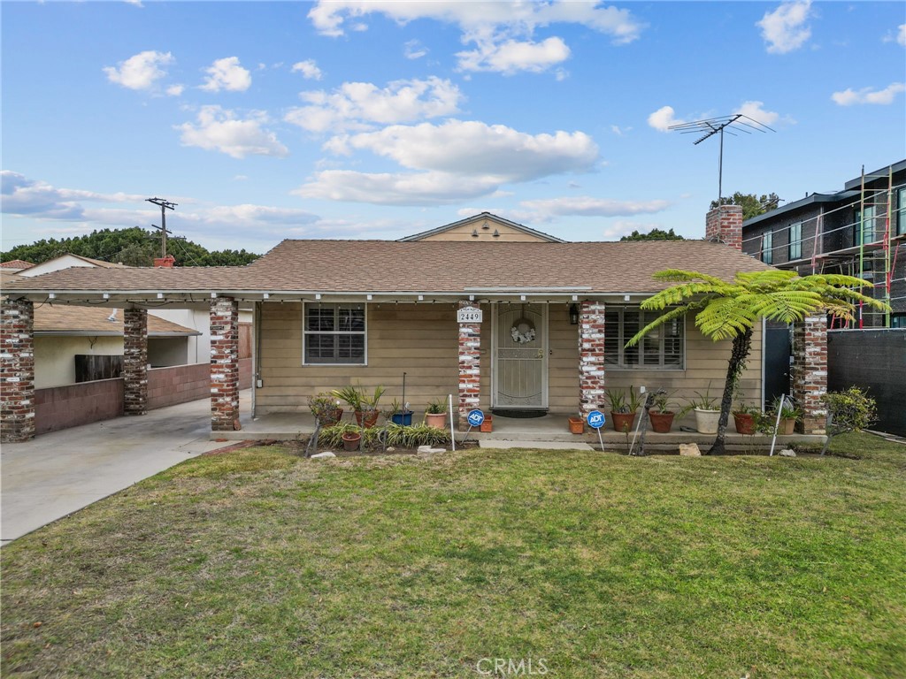 a front view of a house with patio and garden