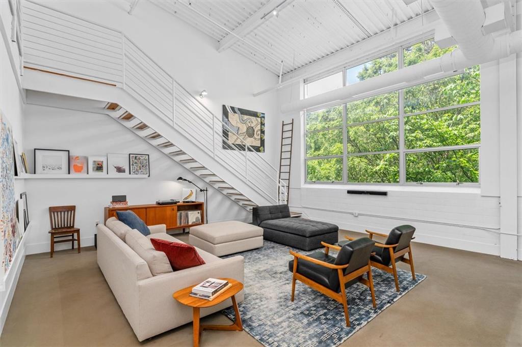 a living room with patio furniture and a large window